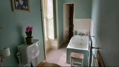 a bathroom with a white sink and a white sinkessment at Gelly Dylan Thomas Paradise in Lampeter