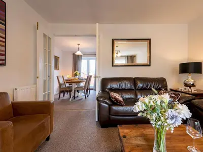 a living room with a leather couch and a table at Town Location for Shrewsbury with 3 Bedrooms - Pass the Keys in Shrewsbury