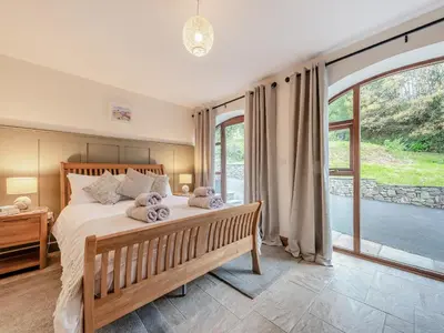 a bedroom with a bed with two stuffed animals on it at Bwlchygwynt in Rhandirmwyn
