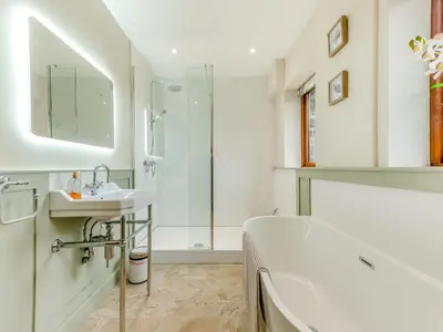 a bathroom with a tub and a sink and a shower at Bwlchygwynt in Rhandirmwyn