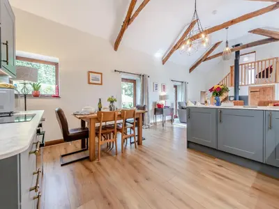 a kitchen and dining room with a table and chairs at Bwlchygwynt in Rhandirmwyn