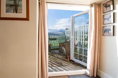 a room with a large window with a view at The Barn in Bala