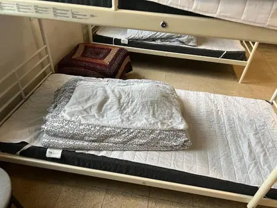 two bunk beds in a room with a mattress at Llanfyllin Workhouse - Y Dolydd in Llanfyllin
