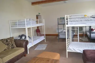 a living room with bunk beds and a couch at Llanfyllin Workhouse - Y Dolydd in Llanfyllin