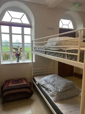 two bunk beds in a room with a window at Llanfyllin Workhouse - Y Dolydd in Llanfyllin
