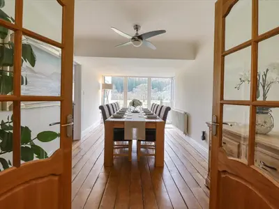a dining room with a table and chairs and a ceiling fan at Tan Yr Allt in Welshpool