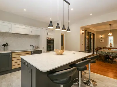 a kitchen with a island with two bar stools at Belle Vue in Hereford
