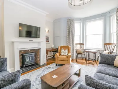 a living room with a fireplace and a tv at Belle Vue in Hereford