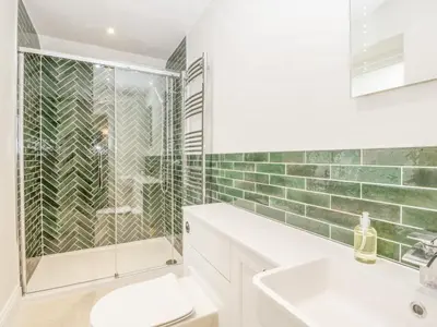 a bathroom with a shower and a toilet and a sink at Belle Vue in Hereford
