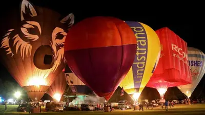 a group of colorful hot air balloons at night at Willowdene shepherds hut in Oswestry