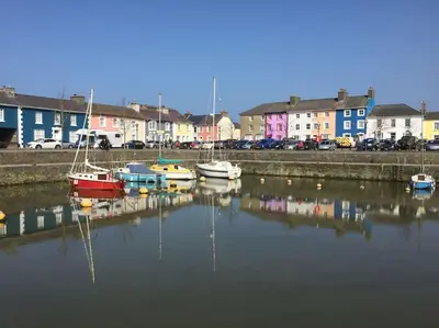 a group of boats are docked in a harbor at Y Villa Môr in Llanarth
