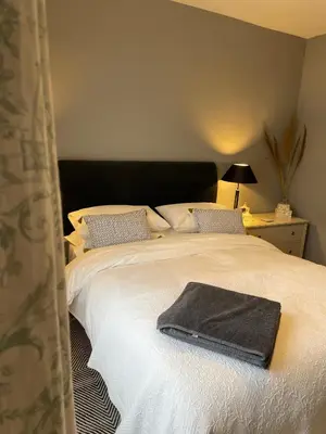 a bed with a black towel on top of it at River walk . Shrewsbury.Shropshire.With parking. in Shrewsbury