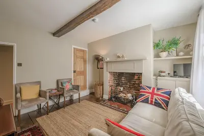 a living room with a couch and a fireplace at St. John’s hill - with parking in Shrewsbury