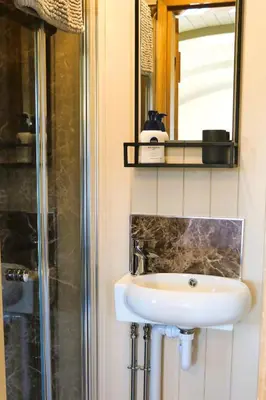 a bathroom with a sink and a mirror at Mayflower in Rhayader