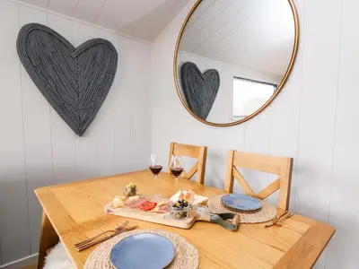 a dining room table with a mirror and blue plates at Fawns Rest in Rhayader