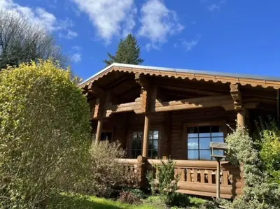 a log cabin with a fence in front of it at Beautiful 2 Bedroom Log Cabin With Private Hot Tub - Elm in Leominster