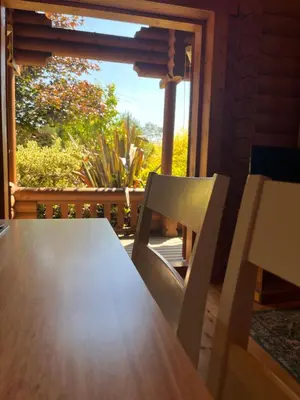 a table and chair in a room with a window at Beautiful 2 Bedroom Log Cabin With Private Hot Tub - Elm in Leominster