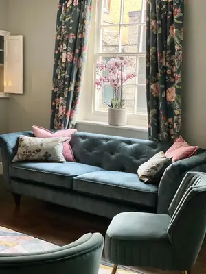 a blue couch in a living room with a window at Hurdley House-Georgian Town House in Montgomery