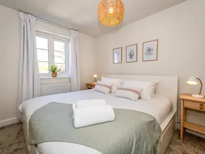 a bedroom with a large white bed and a window at Brand new 1 bedroom modern contemporary apartment - Pass the Keys in Ludlow
