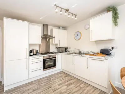 a white kitchen with white cabinets and a sink at Brand new 1 bedroom modern contemporary apartment - Pass the Keys in Ludlow