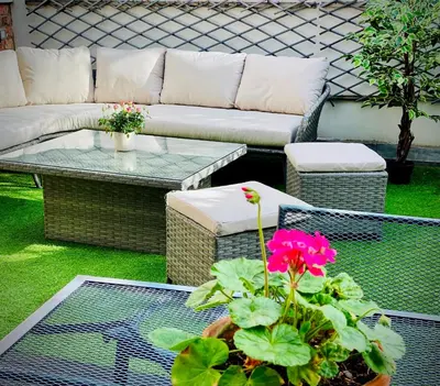 a patio with a couch and a table and a flower at Superbly Located Handsome Georgian Townhouse - Pass the Keys in Shrewsbury