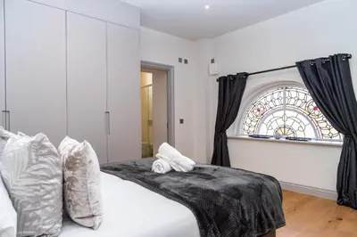 a bedroom with a bed and a stained glass window at The Old Glassworks by Bevolve in Shrewsbury