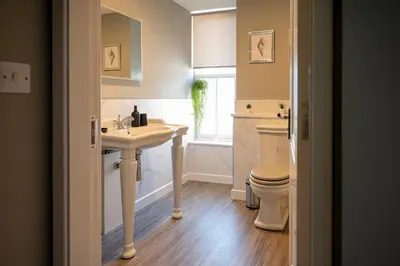a bathroom with a sink and a toilet at The Fanny Talbot in Barmouth