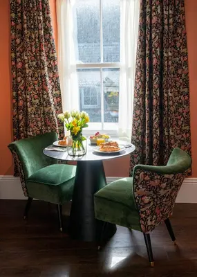 a table with a plate of food and a window at The Fanny Talbot in Barmouth