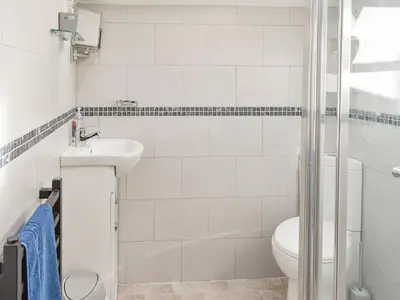 a bathroom with a toilet and a sink and a shower at Tryfar House in Harlech