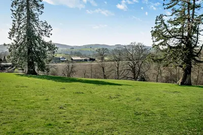a field of green grass with trees in the background at 1 Bed in Builth Wells oc-p27441 in Builth Road