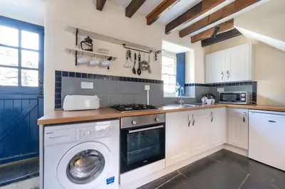 a kitchen with a washer and a washing machine at 2 Bed in Dolgellau oc-wah671 in Dolgellau
