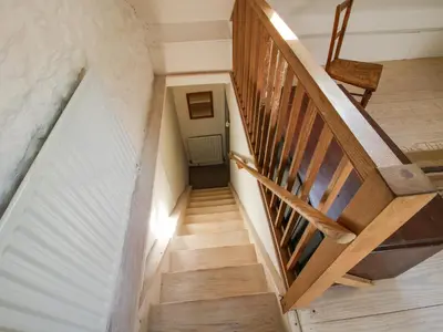 a staircase in a house with wooden floors at 1 Hetfield Cottages in Bishops Castle