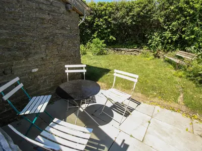 two chairs and a table and a table and chairs at 1 Hetfield Cottages in Bishops Castle