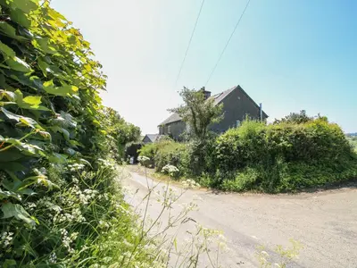 a dirt road in front of a house at 1 Hetfield Cottages in Bishops Castle