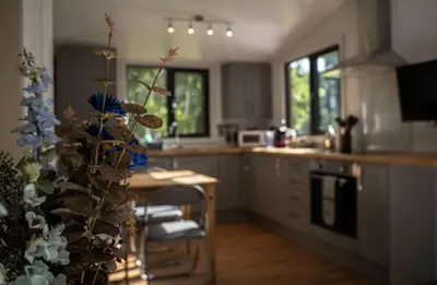 a kitchen with a table and a counter top at Riverside Cabins in Shrewsbury