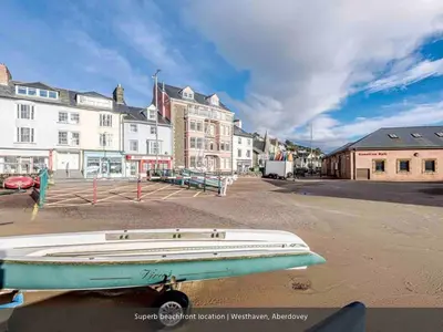 a boat sitting on the street in a town at Seaview Apartment Westhaven in Aberdyfi