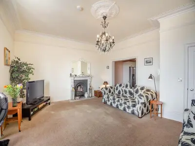a living room with a couch and a tv at Seaview Apartment Westhaven in Aberdyfi