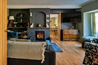 a living room with a couch and a fireplace at Finest Retreats - Felin Ship in Dolgellau