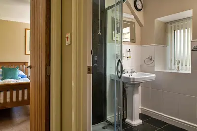 a bathroom with a glass shower and a sink at Finest Retreats - Felin Ship in Dolgellau