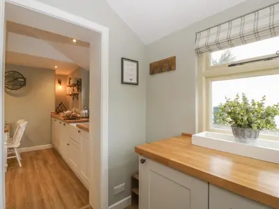 a kitchen with a large window and a counter at Pool Cottage in Hereford