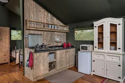 a kitchen with white appliances and wooden walls at 3 Bed in Talybont-on-Usk oc-wal376 in Talybont