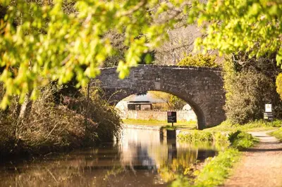 a stone bridge over a river with a body of water at 3 Bed in Talybont-on-Usk oc-wal376 in Talybont
