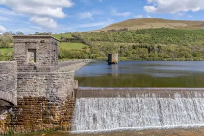 a dam on a river with a waterfall at 3 Bed in Talybont-on-Usk oc-wal376 in Talybont