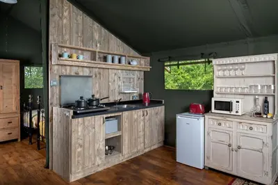 a kitchen with wooden cabinets and a stove top oven at 3 Bed in Talybont On Usk oc-wal375 in Talybont