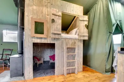 a bunk bed in a room with a fireplace at 3 Bed in Talybont On Usk oc-wal375 in Talybont