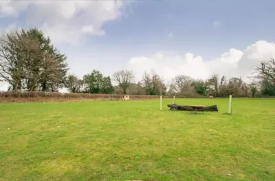 a park with a bench in the middle of a field at 3 Bed in Talybont On Usk oc-wal375 in Talybont