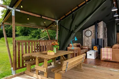 a green tent with a wooden table and bench at 3 Bed in Talybont On Usk oc-wal375 in Talybont