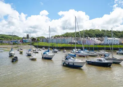 a bunch of boats are docked in the water at Angorfa Aberaeron Apartment in Aberaeron