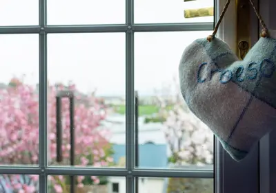 a heart ornament hanging from a window at Angorfa Aberaeron Apartment in Aberaeron