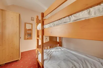 a bedroom with two bunk beds in a room at 2 Bed in Corwen oc-waf161 in Carrog